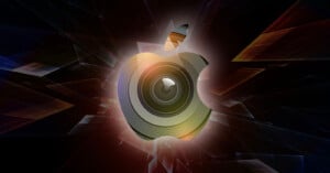 Abstract digital artwork featuring a stylized apple with a lens in the middle, surrounded by dynamic, colorful geometric shapes on a dark background.